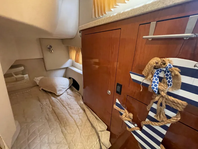 Slide: The Image of 2006 Regal 3060 Window Express cabin interior with bed and wooden cabinetry. - 30
