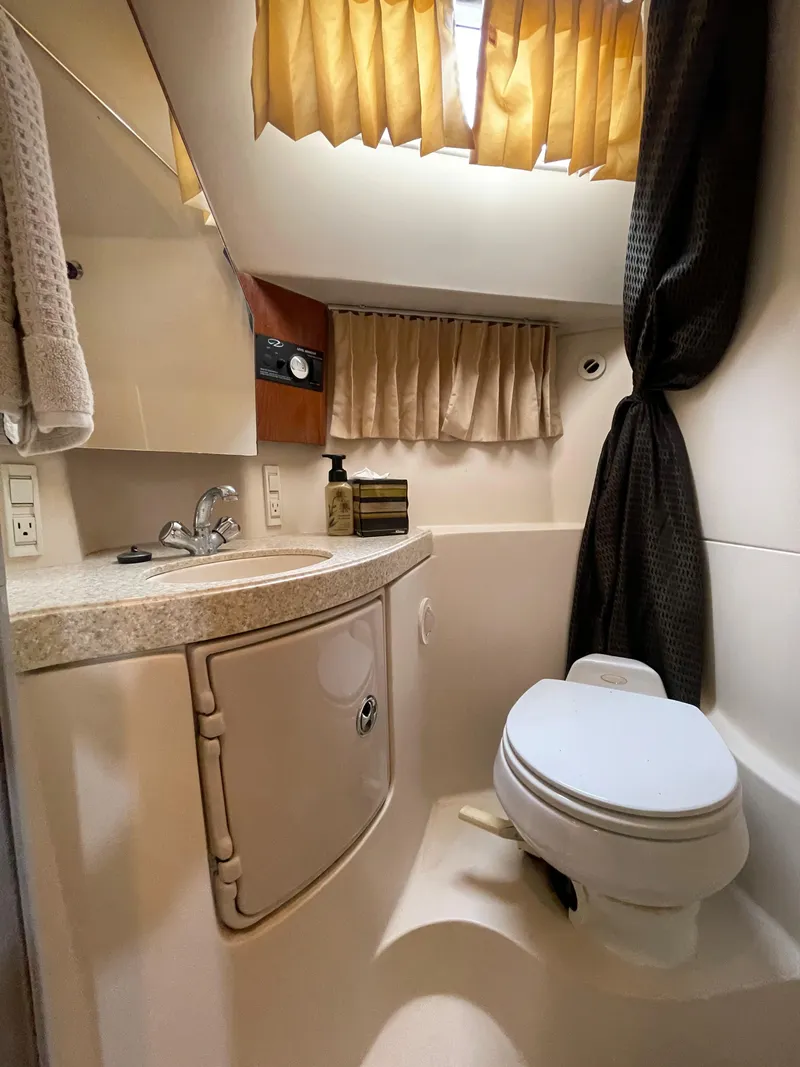 Slide: The Image of 2006 Regal 3060 Window Express boat bathroom with sink, toilet, and curtains. - 32