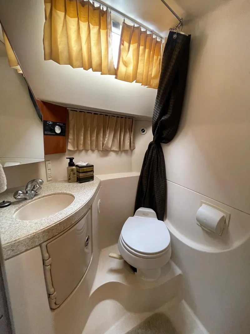 Slide: The Image of 2006 Regal 3060 Window Express boat bathroom with sink, toilet, and shower curtain. - 33