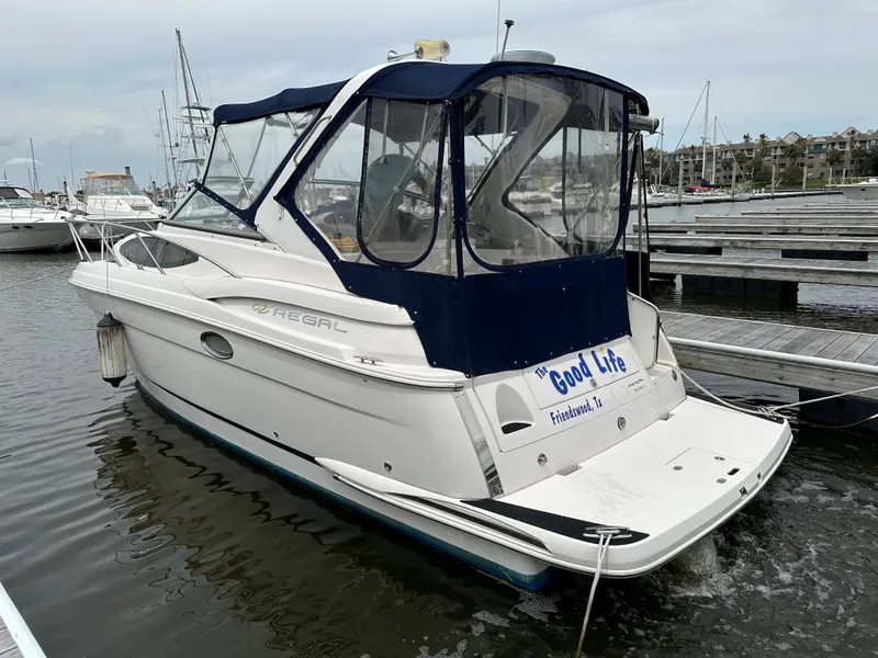 Slide: The Image of 2006 Regal 3060 Window Express boat docked at a marina. - 4