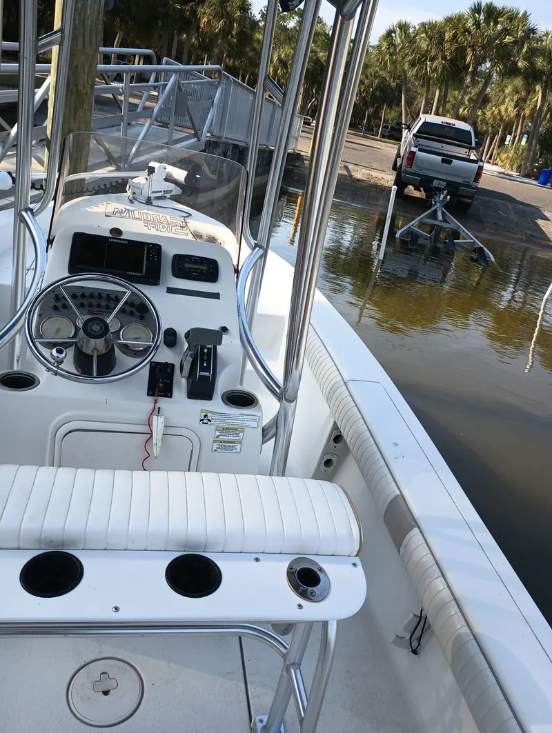 Slide: The Image of 2014 Carolina Skiff Sea Skiff 21 boat interior with steering console and seating. - 10