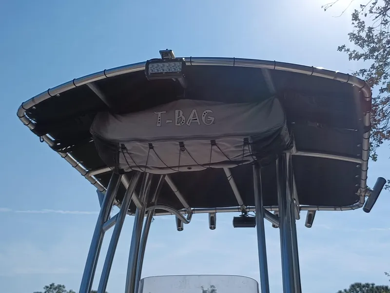 Slide: The Image of 2014 Carolina Skiff Sea Skiff 21 T-top with T-Bag storage under clear blue sky. - 13