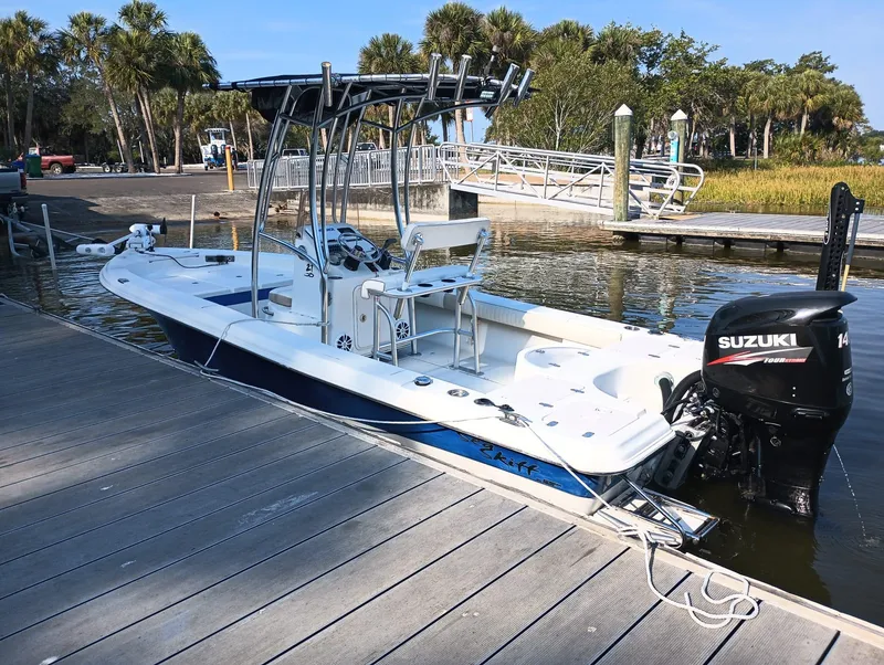 Slide: The Image of 2014 Carolina Skiff Sea Skiff 21 boat docked with Suzuki outboard motor. - 14