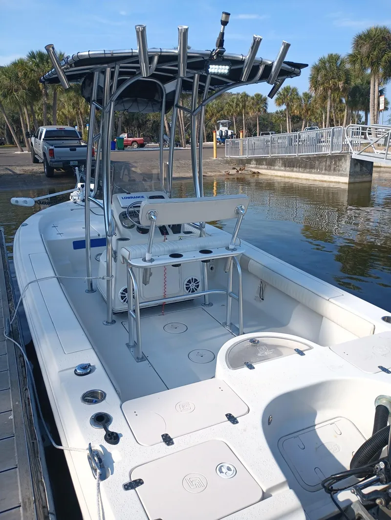 Slide: The Image of 2014 Carolina Skiff Sea Skiff 21 boat docked at a marina. - 18