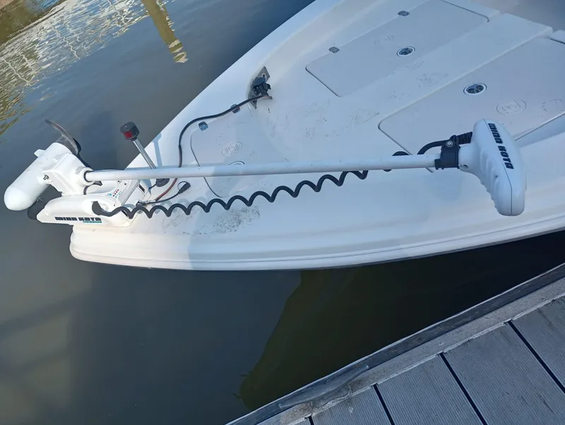Slide: The Image of 2014 Carolina Skiff Sea Skiff 21 with trolling motor docked. - 25