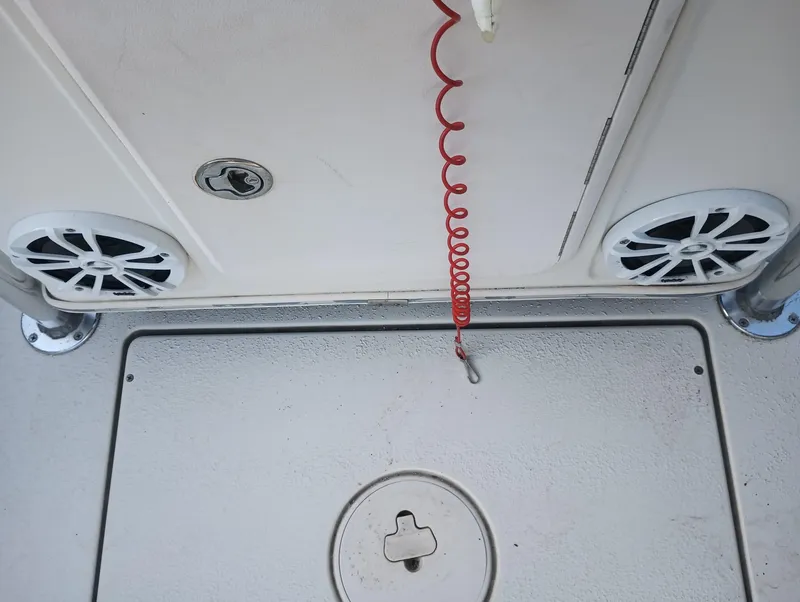 Slide: The Image of 2014 Carolina Skiff Sea Skiff 21 boat deck with speakers and red coiled cord. - 26