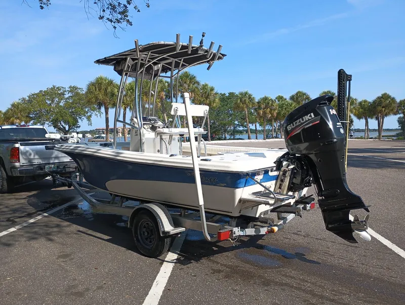 Slide: The Image of 2014 Carolina Skiff Sea Skiff 21 boat on trailer with Suzuki outboard motor. - 30