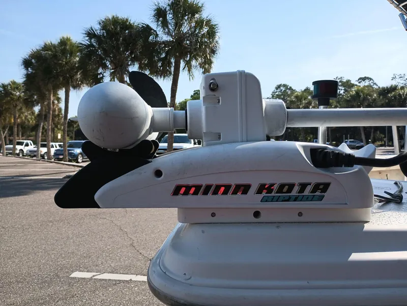 Slide: The Image of Minn Kota trolling motor on 2014 Carolina Skiff Sea Skiff 21 boat, parked near palm trees. - 35
