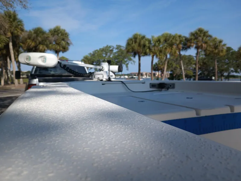 Slide: The Image of 2014 Carolina Skiff Sea Skiff 21 boat with palm trees in the background. - 4