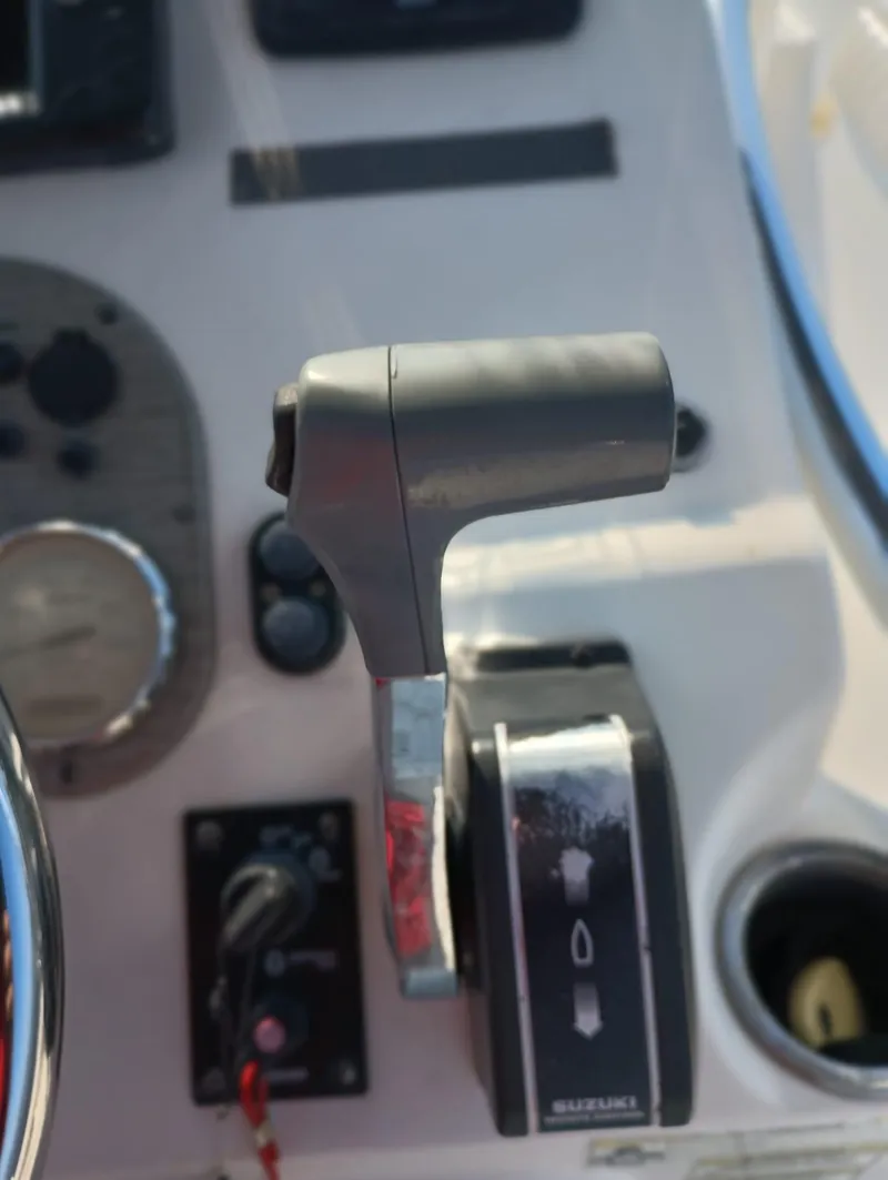 Slide: The Image of Close-up of the control panel and throttle of a 2014 Carolina Skiff Sea Skiff 21. - 40