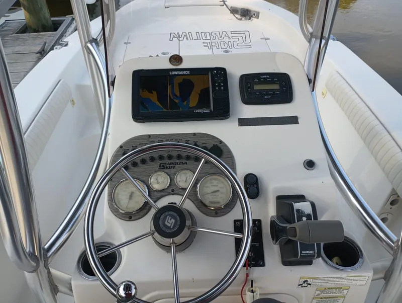 Slide: The Image of 2014 Carolina Skiff Sea Skiff 21 boat console with steering wheel and navigation equipment. - 5
