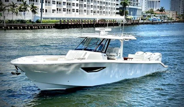 Slide: The Image of 2022 Pursuit S-378 Sport boat cruising on water near urban waterfront. - 0