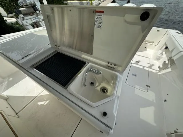 Slide: The Image of 2022 Pursuit S-378 Sport boat with open sink and grill station. - 13