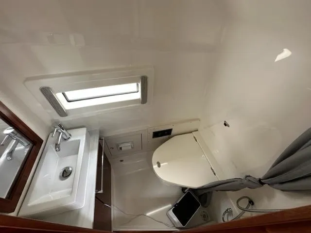 Slide: The Image of 2022 Pursuit S-378 Sport boat bathroom with sink, toilet, and window. - 16
