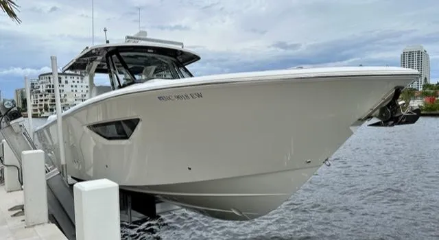 Slide: The Image of 2022 Pursuit S-378 Sport boat docked at a marina. - 4