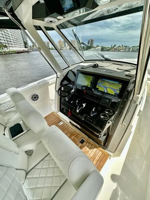 Slide: The Image of 2022 Pursuit S-378 Sport boat cockpit with advanced navigation system. - 7