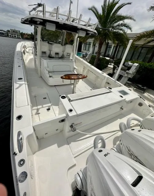 Slide: The Image of 2022 Pursuit S-378 Sport boat with spacious deck and twin outboard engines. - 8