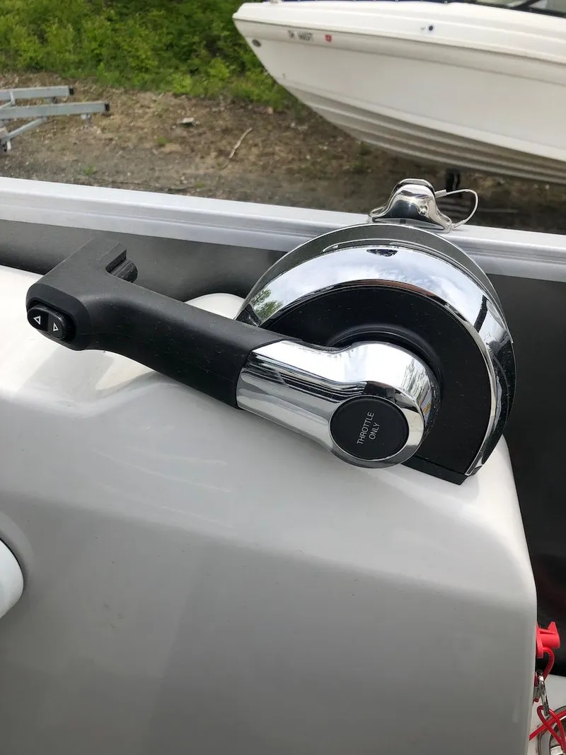 Slide: The Image of Boat throttle control on a 2023 Lowe 250 model. - 11
