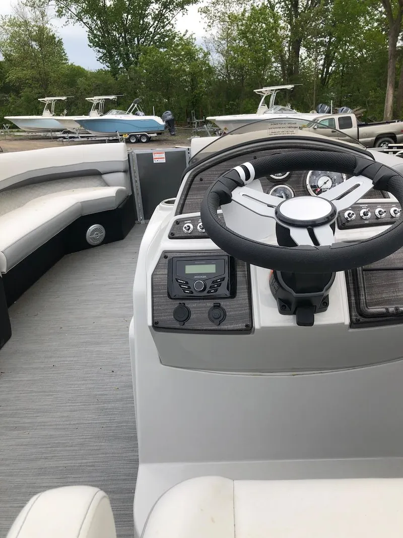 Slide: The Image of 2023 Lowe 250 boat interior with steering wheel and seating. - 12