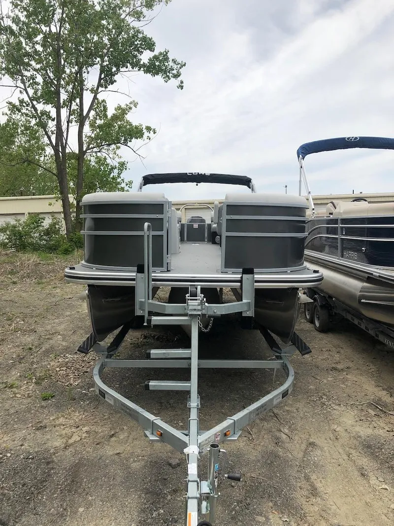 Slide: The Image of 2023 Lowe 250 pontoon boat on trailer, front view. - 3