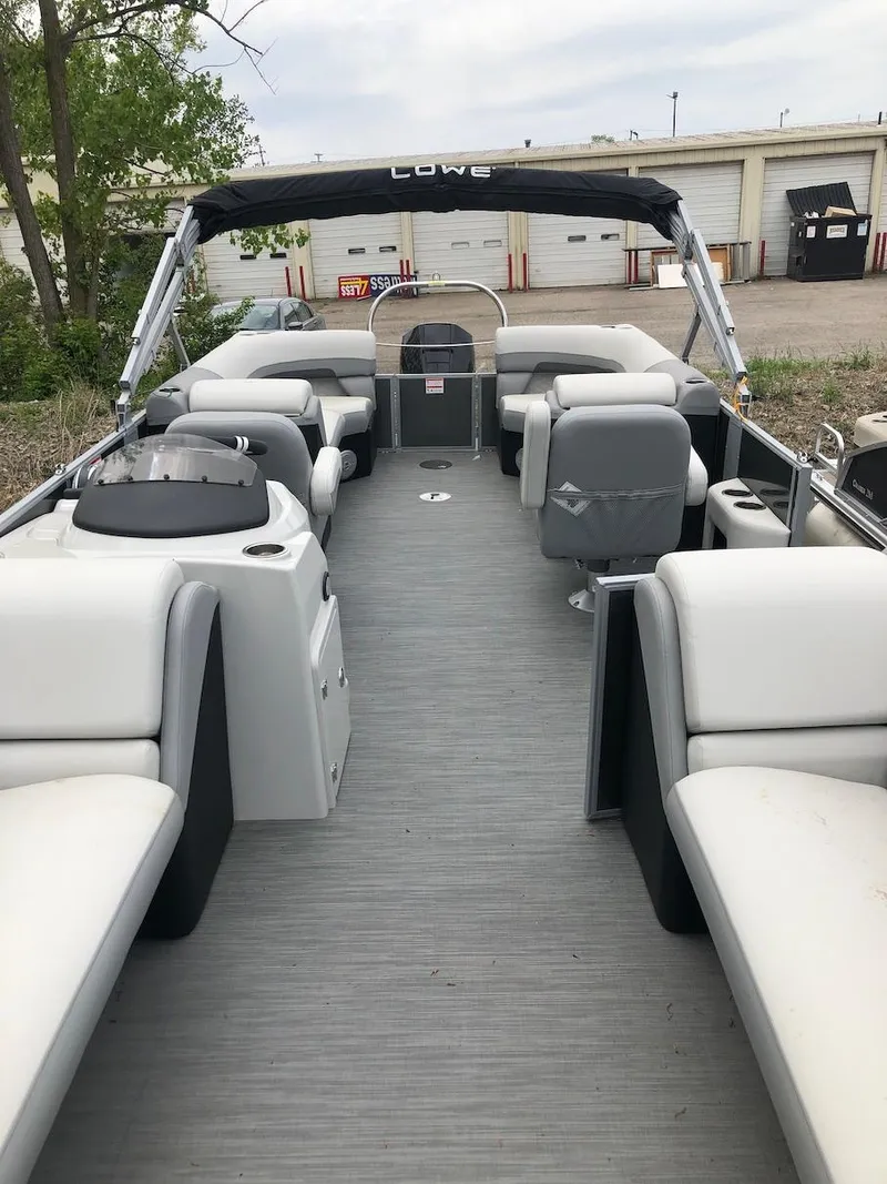 Slide: The Image of 2023 Lowe 250 pontoon boat with spacious seating and modern design. - 5