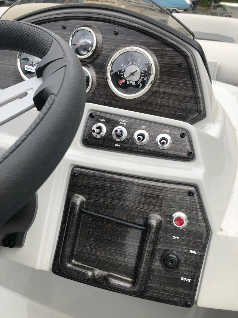 Slide: The Image of Control panel of a 2023 Lowe 250 boat with gauges and switches. - 9