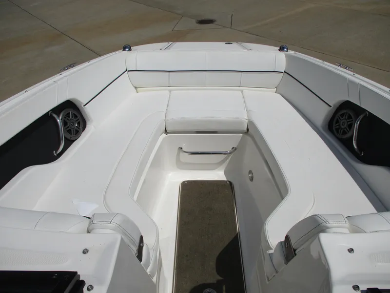 Slide: The Image of 2015 Sea Ray 240 Sundeck interior with white seating and speakers. - 10