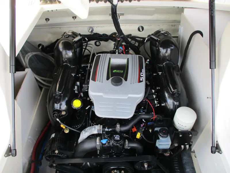 Slide: The Image of 2015 Sea Ray 240 Sundeck engine compartment, showcasing a powerful inboard motor. - 12