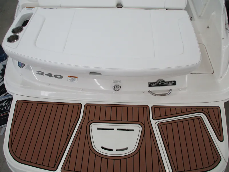 Slide: The Image of 2015 Sea Ray 240 Sundeck boat with teak-style swim platform and seating area. - 14