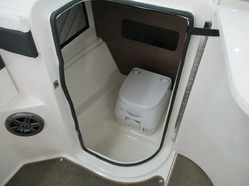Slide: The Image of 2015 Sea Ray 240 Sundeck boat interior with compact marine toilet. - 18