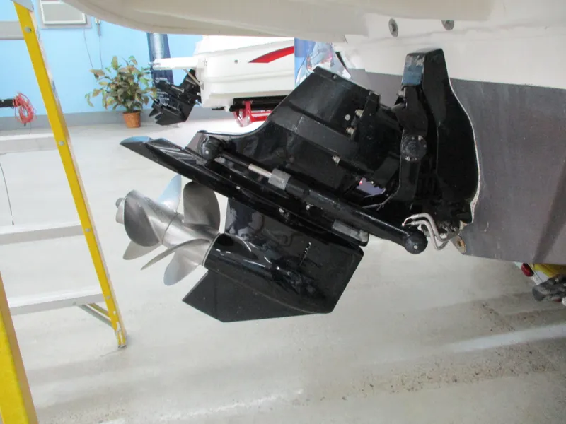 Slide: The Image of 2015 Sea Ray 240 Sundeck boat propeller and stern drive in a showroom. - 20