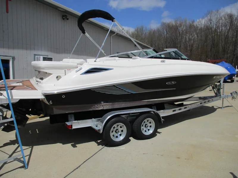 Slide: The Image of 2015 Sea Ray 240 Sundeck boat on trailer, parked outdoors. - 3