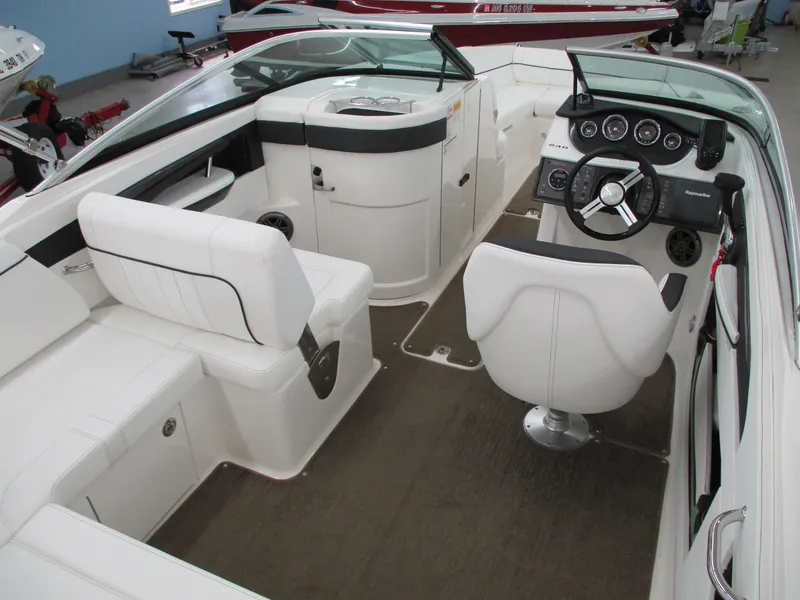 Slide: The Image of 2015 Sea Ray 240 Sundeck interior with white seating and modern dashboard. - 4