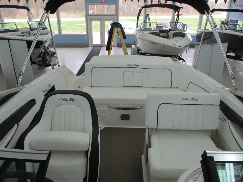Slide: The Image of 2015 Sea Ray 240 Sundeck interior with white seating in showroom. - 5