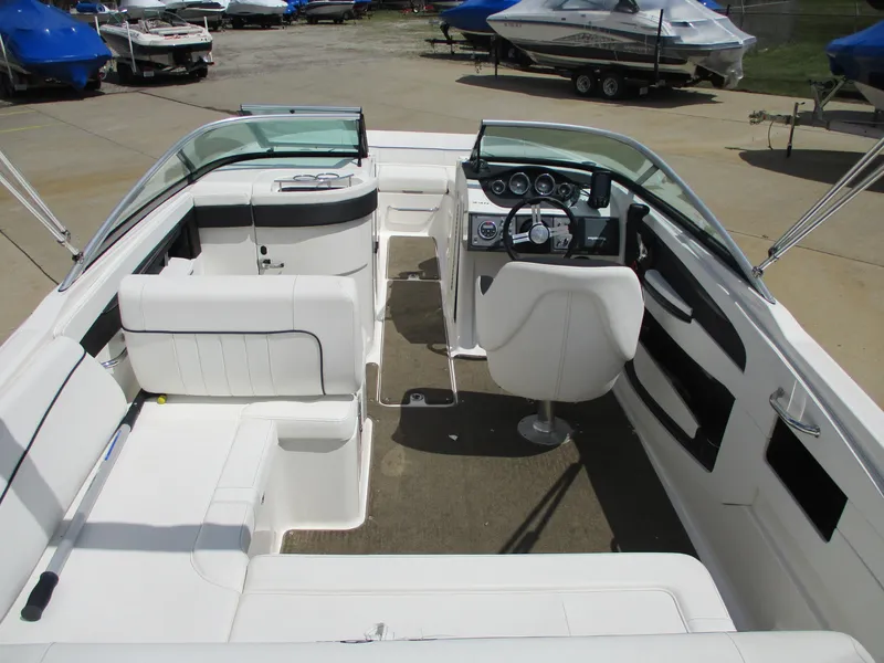Slide: The Image of 2015 Sea Ray 240 Sundeck interior with white seating and modern dashboard. - 7
