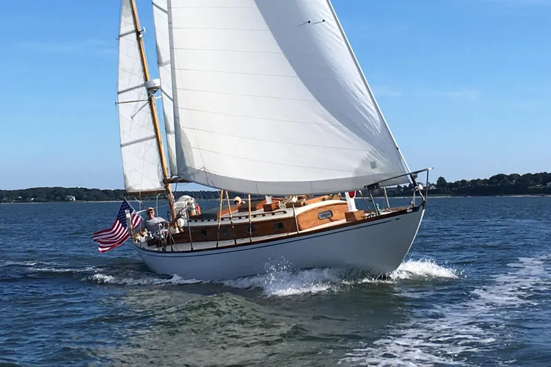 The Image of Sailing yacht Sparkman & Stephens Nevins 40, 1958, gliding on water with American flag. - 0