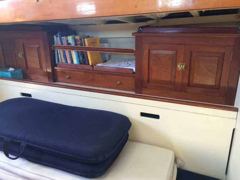 Slide: The Image of 1958 Sparkman & Stephens Nevins 40 yacht deck with wooden details, moored on calm water. - 12