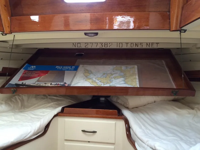 Slide: The Image of 1958 Sparkman & Stephens Nevins 40 yacht interior with wooden finish and blue seating. - 15