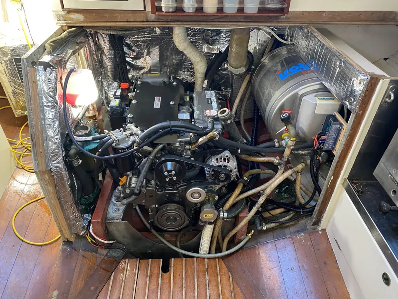 Slide: The Image of Interior of 1958 Sparkman & Stephens Nevins 40 yacht, featuring classic wooden design and compact kitchen. - 19