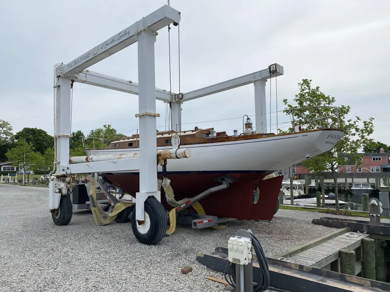 Slide: The Image of 1958 Sparkman & Stephens Nevins 40 sailboat on a boat lift at a marina. - 27