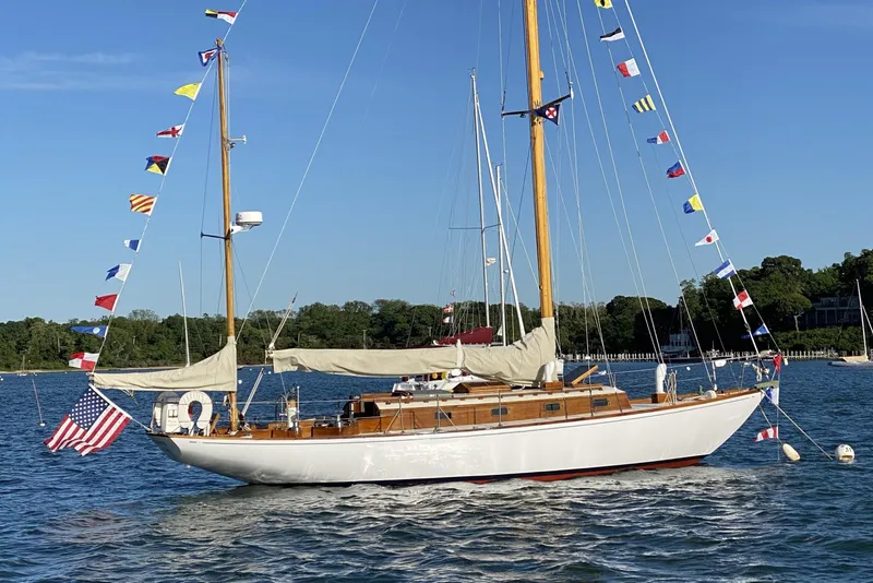 Slide: The Image of 1958 Sparkman & Stephens Nevins 40 sailboat cruising on open water under a clear sky. - 3