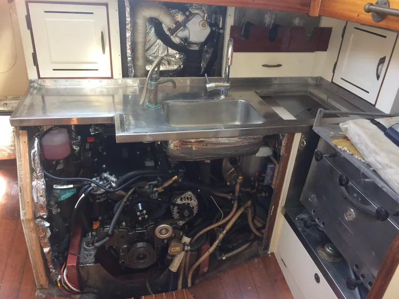 Slide: The Image of 1958 Sparkman & Stephens Nevins 40 yacht kitchen with engine access under stainless steel sink. - 31