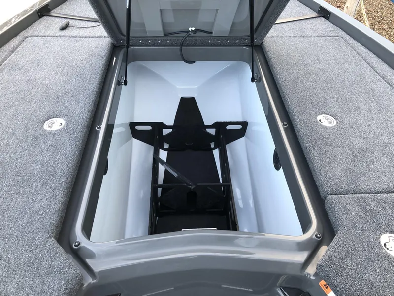 Slide: The Image of 2024 iKon LX20 boat storage compartment with open lid. - 10