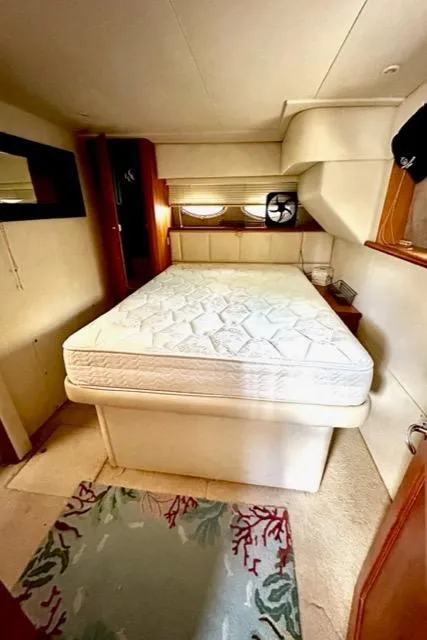 Slide: The Image of 2000 Silverton 392 Motor Yacht bedroom with queen bed and nautical decor. - 14