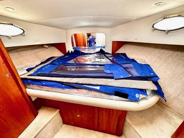 Slide: The Image of Interior cabin of 2000 Silverton 392 Motor Yacht with bed and blue covers. - 19