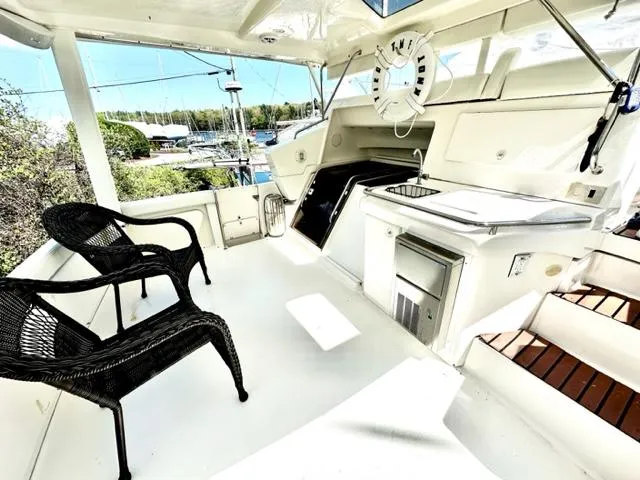 Slide: The Image of 2000 Silverton 392 Motor Yacht interior with seating and kitchenette. - 22