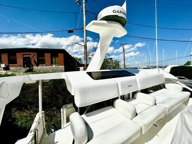 Slide: The Image of 2000 Silverton 392 Motor Yacht with Garmin radar, white seating, and clear blue sky. - 23