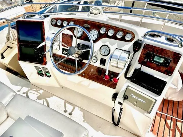 Slide: The Image of Helm of a 2000 Silverton 392 Motor Yacht with navigation equipment and controls. - 24