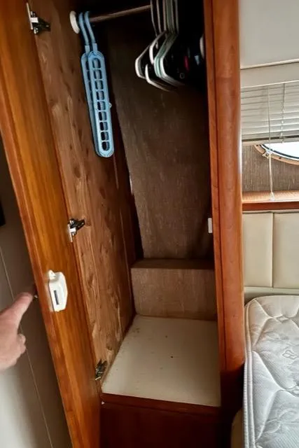 Slide: The Image of 2000 Silverton 392 Motor Yacht interior closet with hangers and storage space. - 29