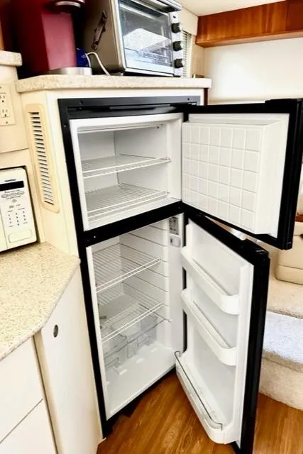 Slide: The Image of 2000 Silverton 392 Motor Yacht kitchen with open refrigerator and microwave. - 30